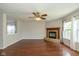 Inviting living room with a brick fireplace, hardwood floors, and large windows for plenty of natural light at 14523 Lee Stewart Ln, Fishers, IN 46038