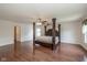 Large primary bedroom with hardwood floors, ceiling fan and ensuite bath at 14523 Lee Stewart Ln, Fishers, IN 46038