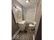 Cozy bathroom with a tub, tiled sink, mirror, and a toilet with sleek new wood-look flooring at 1521 N Tacoma Ave, Indianapolis, IN 46201
