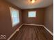 A bedroom has neutral walls, two windows for natural light, and hardwood floors at 1521 N Tacoma Ave, Indianapolis, IN 46201