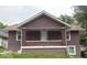Charming brown exterior showcasing the home's covered porch and classic architectural style at 1521 N Tacoma Ave, Indianapolis, IN 46201