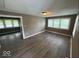 Spacious living room featuring new flooring and natural light from multiple windows at 1521 N Tacoma Ave, Indianapolis, IN 46201