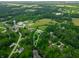 Aerial view showcases property boundaries amidst verdant landscape, highlighting its location and natural surroundings at 155 Hoover Dr, , IN 46164