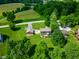 Aerial view of home with a detached garage and patio surrounded by lush trees and grassy lawn at 155 Hoover Dr, , IN 46164