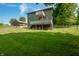 Expansive green backyard featuring a two-story walk out deck and utility shed at 155 Hoover Dr, , IN 46164