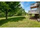 Large green backyard featuring a two-story deck and mature trees at 155 Hoover Dr, , IN 46164
