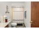 Bright bathroom features a tub with stylish shower curtain, wood-look flooring and vanity at 155 Hoover Dr, , IN 46164