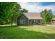 Charming home with a cozy covered porch and manicured lawn with mature trees at 155 Hoover Dr, , IN 46164