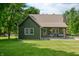Charming home with a cozy covered porch, complemented by manicured lawn and mature trees at 155 Hoover Dr, , IN 46164