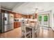 An eat-in kitchen with stainless steel appliances, wooden cabinets, a ceiling fan, and access to the back deck at 155 Hoover Dr, , IN 46164