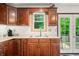 Kitchen counter with wooden cabinets and a window with a view of the outdoors at 155 Hoover Dr, , IN 46164