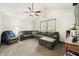 Living room with a large gray sectional couch, carpeted floors, a ceiling fan, and natural light at 155 Hoover Dr, , IN 46164
