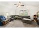 Living room with a large gray sectional couch, carpeted floors, a ceiling fan, and natural light at 155 Hoover Dr, , IN 46164