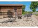 Outdoor patio area with gravel, fire pit and iron chairs at 155 Hoover Dr, , IN 46164