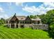 Expansive backyard featuring an in-ground pool, large manicured lawn, and mature trees at 18 Lost Run Ln, Zionsville, IN 46077