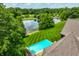Rooftop view of pool and a spacious backyard with lush lawn and mature landscaping at 18 Lost Run Ln, Zionsville, IN 46077