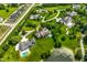 Sprawling community aerial view with lush landscaping, mature trees and a large pond at 18 Lost Run Ln, Zionsville, IN 46077