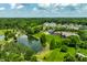 Aerial view of the community highlighting a large pond, lush landscaping and mature trees at 18 Lost Run Ln, Zionsville, IN 46077