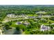 Aerial view of a luxurious community featuring manicured lawns, well-spaced homes, and a tranquil pond at 18 Lost Run Ln, Zionsville, IN 46077