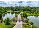 Aerial view of the property entrance with a gate and tree lined drive at 18 Lost Run Ln, Zionsville, IN 46077