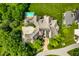 Aerial view of home featuring spacious backyard with pool, patio and lush lawn at 18 Lost Run Ln, Zionsville, IN 46077