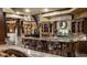 Entertainers basement bar with custom cabinets, granite countertops, and seating for six at 18 Lost Run Ln, Zionsville, IN 46077