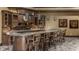 Luxurious basement bar featuring granite countertops, custom cabinetry, and built in clock at 18 Lost Run Ln, Zionsville, IN 46077