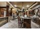 Finished basement bar with stone accents, ornate wood details, and a fireplace in the entertaining area at 18 Lost Run Ln, Zionsville, IN 46077