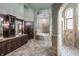 Luxurious bathroom features a stylish walk-in shower, soaking tub and gorgeous vanity with marble counters at 18 Lost Run Ln, Zionsville, IN 46077