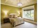 Bright bedroom with a large window, neutral walls, plush carpet, and a decorative chandelier at 18 Lost Run Ln, Zionsville, IN 46077