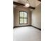 Neutral empty room boasting a large window, carpet, and wooden details at 18 Lost Run Ln, Zionsville, IN 46077