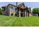 Back of beautiful home with stone and stained wood features at 18 Lost Run Ln, Zionsville, IN 46077
