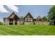 Back of beautiful home with stone and stained wood features at 18 Lost Run Ln, Zionsville, IN 46077