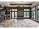 Open kitchen and dining area featuring custom cabinets, stainless appliances, and travertine floors at 18 Lost Run Ln, Zionsville, IN 46077