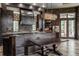 Beautiful custom kitchen with dark wood cabinets, island, and stainless steel appliances at 18 Lost Run Ln, Zionsville, IN 46077