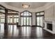 Bright living room featuring hardwood floors, large windows, and fireplace for a warm and inviting atmosphere at 18 Lost Run Ln, Zionsville, IN 46077