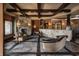 Cozy living room with a stone fireplace and a wine cellar in a luxury home at 18 Lost Run Ln, Zionsville, IN 46077