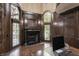 Executive office featuring a fireplace, custom woodwork, and large windows providing natural light at 18 Lost Run Ln, Zionsville, IN 46077