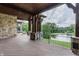 Beautiful outdoor porch featuring stone accents, wood flooring and gorgeous views of the water at 18 Lost Run Ln, Zionsville, IN 46077