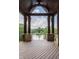 Stunning outdoor porch with stone details, wooden ceiling, and breathtaking views of the nearby lake at 18 Lost Run Ln, Zionsville, IN 46077