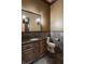 Elegant powder room featuring a custom vanity, stone accents, and modern fixtures at 18 Lost Run Ln, Zionsville, IN 46077