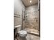 Bathroom featuring a walk-in shower with river rock floor and ceramic tile surround at 18 Lost Run Ln, Zionsville, IN 46077