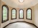 Bright sitting area with arched windows providing abundant natural light and views at 18 Lost Run Ln, Zionsville, IN 46077