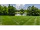 Beautiful backyard with landscaping, trees, and pond at 18 Lost Run Ln, Zionsville, IN 46077