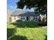 Well-maintained backyard with lush lawn, patio seating, and a garden area, perfect for relaxing outdoors at 1820 Irish Lake Ln, Indianapolis, IN 46239