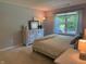 Bright bedroom featuring a large window, neutral color palette, and carpet flooring at 1820 Irish Lake Ln, Indianapolis, IN 46239