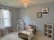 bedroom featuring a doll house, chandelier, and a comfy bed at 1820 Irish Lake Ln, Indianapolis, IN 46239