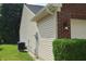 Home exterior showing light siding, brick accents, an outdoor light fixture, and green landscaping at 1820 Irish Lake Ln, Indianapolis, IN 46239