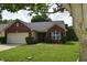Cozy brick home with a well-kept lawn and landscaping, showcasing curb appeal and a welcoming atmosphere at 1820 Irish Lake Ln, Indianapolis, IN 46239