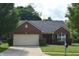Well-maintained single-Gathering brick home with an attached garage, neat lawn, and tidy landscaping at 1820 Irish Lake Ln, Indianapolis, IN 46239